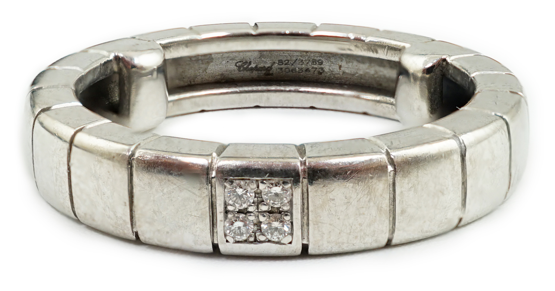 A modern Chopard 18ct white gold and four stone diamond chip cluster set band